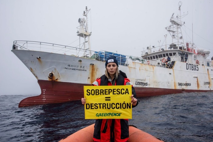 Luisina Vueso ante el pesquero surcoreano Meridian Nº 8 que saquea la rica biodiversidad del Agujero Azul en el Atlántico | Foto: Greenpeace 